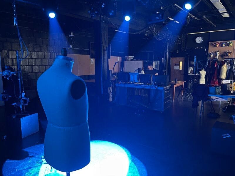 Three Elation Fuze Max Spot fixtures shining blue light onto the bust of a mannequin.