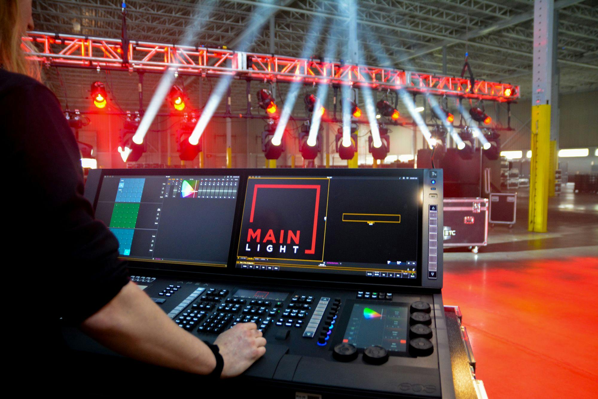 ETC EOS Apex 10 being used to program ETC Lonestars on a rack of truss. The Main Light logo is visible on the Apex 10 screen.