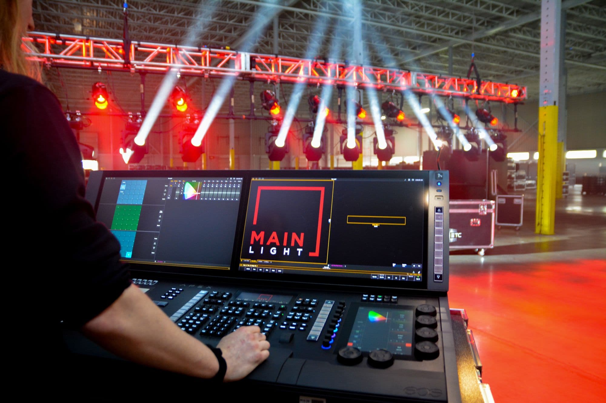 ETC EOS Apex 10 being used to program ETC Lonestars on a rack of truss. The Main Light logo is visible on the Apex 10 screen.